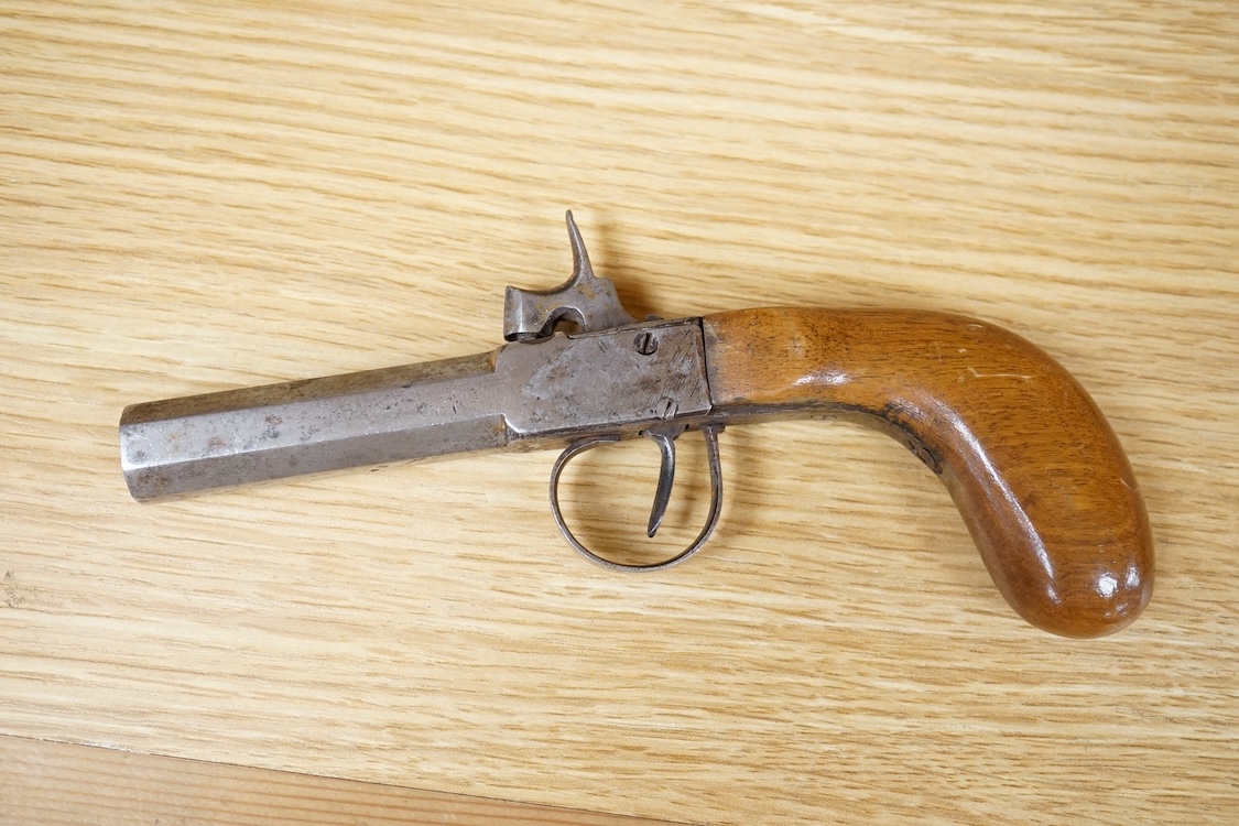 A Belgian boxlock percussion pocket pistol with octagonal barrel, hammer offset for sighting, and rounded wooden butt